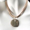 Six Strands of Genuine Leather holds a Drilled Beach Rock